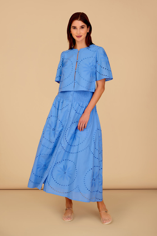 Blue eyelet cropped blouse with short sleeves and front slit detail paired with matching midi skirt