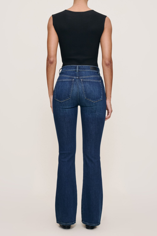 Model wearing the DL1961 Bridget Boot Jean in Sea Front with a high-rise bootcut silhouette.