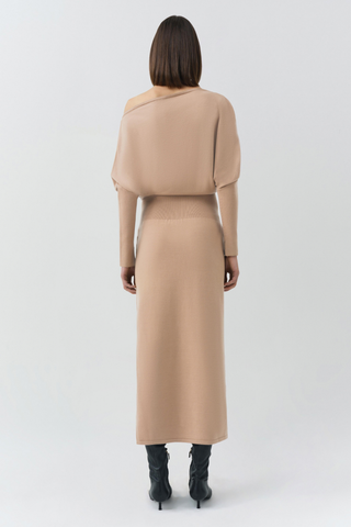 SIMKHAI Janese Off Shoulder Midi Dress in Camel featuring a wide off-the-shoulder neckline, fitted waist, and straight midi skirt.
