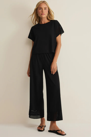 Z Supply Banyan Crochet Pant in Black featuring a relaxed straight-leg silhouette, elastic waistband, and crochet lace trim at the hem