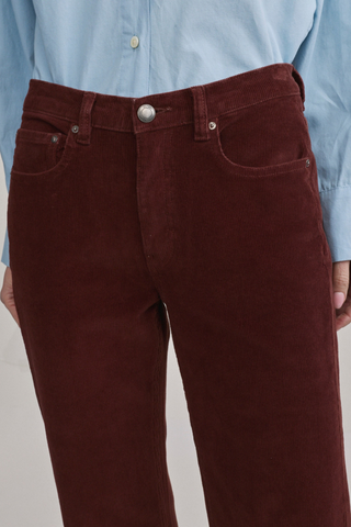 DL1961 Bella Slim Boot Jean in Syrah Cord featuring a mid-rise slim bootcut silhouette in muted red corduroy.