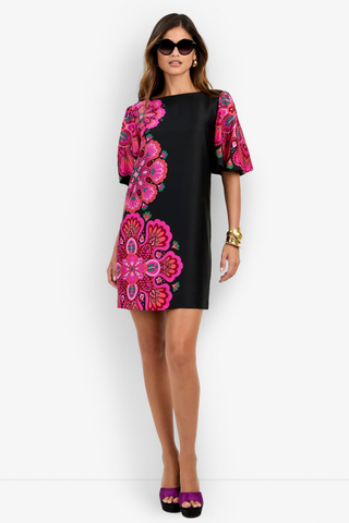 Trina Turk Luv Dress in Multi featuring a black mini silhouette with oversized pink floral print, boat neckline, and short bubble sleeves.