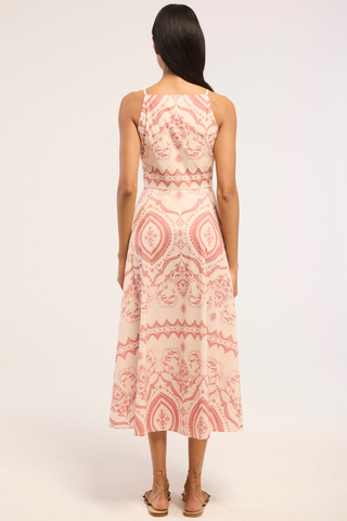 Model wearing the Misa Amity Dress in Terra Ceramic featuring a sleeveless fitted bodice, high neckline, Terra Ceramic print, and box-pleated midi skirt.