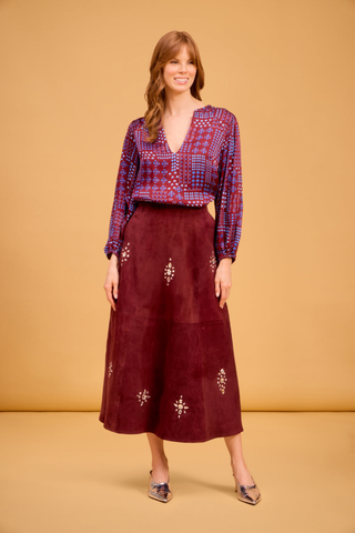 Olivia by Livro Effie Top in Alpine Sprigs featuring a burgundy, pink, and blue geometric floral print, deep V-neckline, and long sleeves.