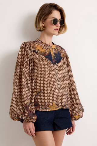 Marie Oliver Rhiannon Top in Flores featuring a brown mixed print, contrasting yoke, stand collar, button placket, and long gathered sleeves.