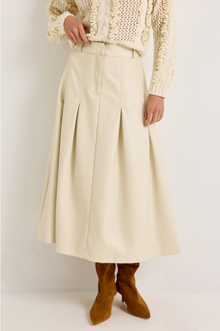 Faith Skirt in Polar featuring a cream vegan leather midi silhouette with a fitted waist and inverted box pleats.