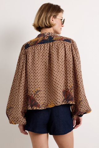 Marie Oliver Rhiannon Top in Flores featuring a brown mixed print, contrasting yoke, stand collar, button placket, and long gathered sleeves.