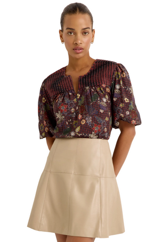 Marie Oliver Crawford Skirt in Oat featuring soft neutral vegan leather, a fitted high waist, pick-stitch detailing, and flared A-line mini silhouette.