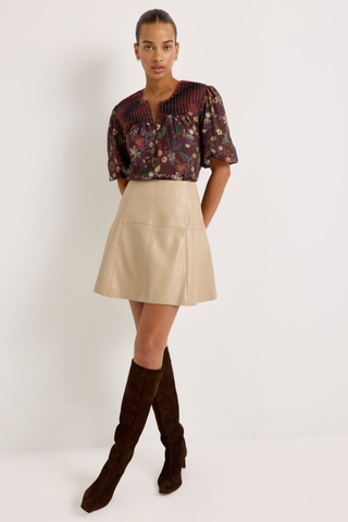 Marie Oliver Crawford Skirt in Oat featuring soft neutral vegan leather, a fitted high waist, pick-stitch detailing, and flared A-line mini silhouette.