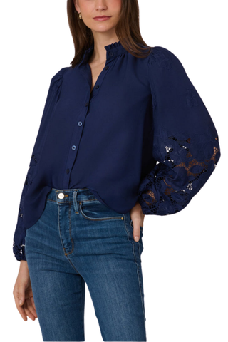 Model wearing the Shoshanna Ingrid Top in Navy featuring embroidered sleeves, a ruffle neckline, and relaxed fit.