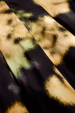 Marie Oliver Faith Skirt in Lush featuring a black and yellow abstract floral print, feminine box pleats, and flowing midi silhouette.