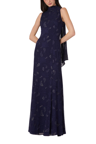 Model wearing the Shoshanna Quinn Dress in Navy/Gold featuring metallic chiffon, a sleeveless high neckline, and flowing full-length skirt.