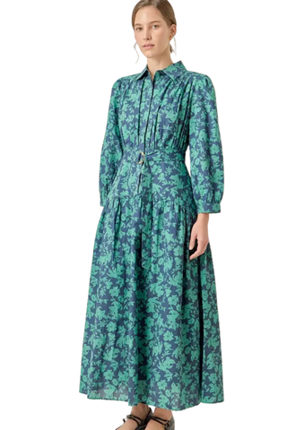 Woman wearing a green floral dress on a white background