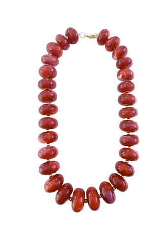 Gemelli Liberty Chunky Beaded Necklace in Red featuring oversized glossy marbled red beads with gold-plated accents and an adjustable clasp.