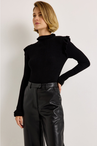 Marie Oliver Tinley Turtleneck in Black featuring fine ribbing, a fitted silhouette, fold-over ruffle neck, and ruffled cuffs.