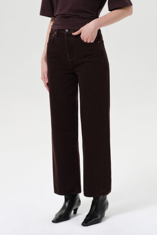 Model wearing the AGOLDE Ren Jean in Sloe Berry featuring a high-rise waist, cropped wide-leg silhouette, and rich dark grape denim with warm brown undertones.