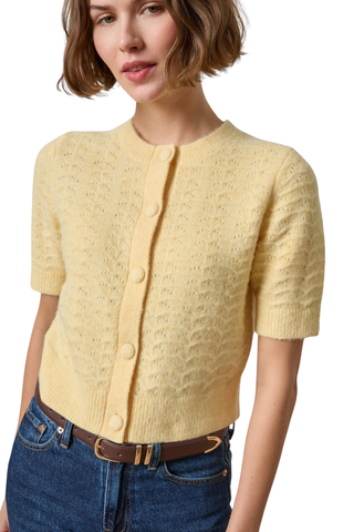 Woman wearing the Lilla P Short Sleeve Crewneck Cardigan in Buttercream, a pale yellow button-front knit cardigan.
