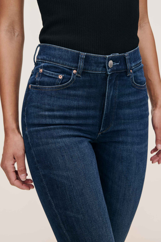 Model wearing the DL1961 Bridget Boot Jean in Sea Front with a high-rise bootcut silhouette.