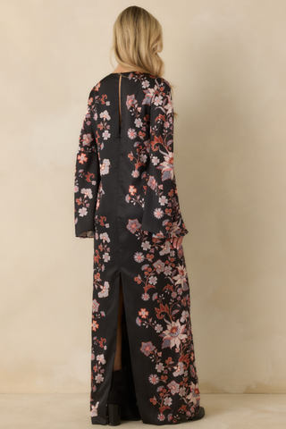 Prosperina Nix Maxi Dress in Nocturne featuring a long-sleeve black floral maxi silhouette with warm pink and rust-toned flowers.