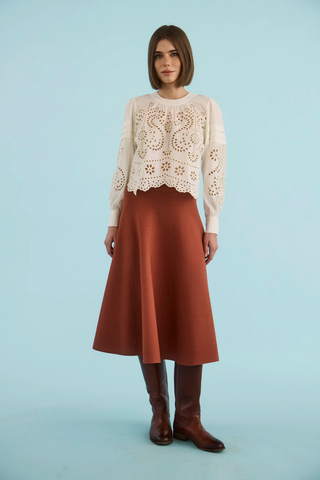 Ivory embroidered cotton eyelet blouse with long sleeves.