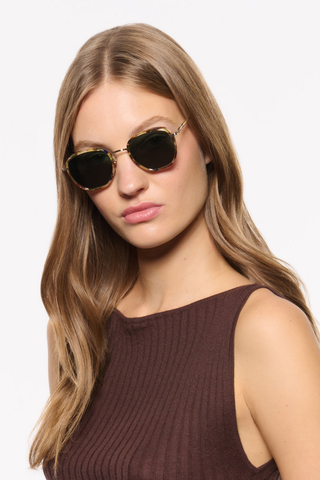 Krewe Peyton Sunglasses in Tuscan Tortoise featuring a tortoise acetate frame, gold-tone hardware, and dark green lenses.