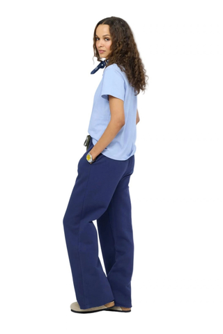 Kerri Rosenthal Weekend Barb Sweatpant in indigo blue featuring a wide-leg silhouette, elastic waistband, and embroidered heart detail.