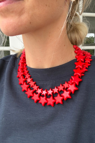 Smith & Co. Design Large Star Necklace in Bright Red featuring oversized fiery red star-shaped beads and a lobster clasp closure.