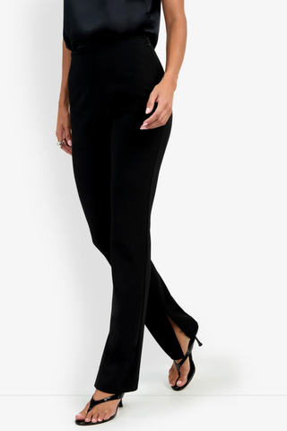 Trina Turk Milena Pant in black featuring a slim-leg silhouette, flat front, side zip closure, and subtle inner hem slits.
