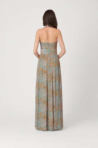 Woman wearing a strapless, long, patterned dress on a white background