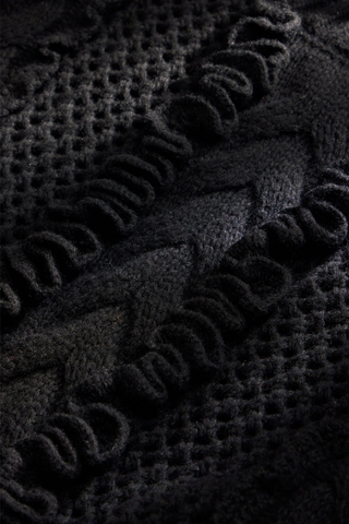 Marie Oliver Lindsay Sweater in Black featuring open-knit detailing, sculptural ruffles, and a classic crew neckline.