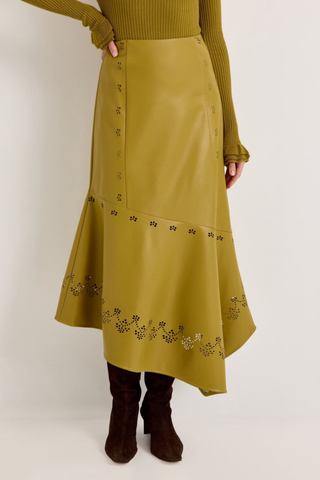 Marie Oliver Casey Skirt in Willow featuring vivid chartreuse vegan leather, laser-cut floral details, and an asymmetrical midi hem.