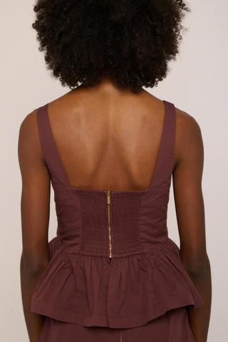 Love the Label Earnshaw Top in Deep Mahogany featuring a sleeveless fitted bodice with a softly flared peplum-style hem.