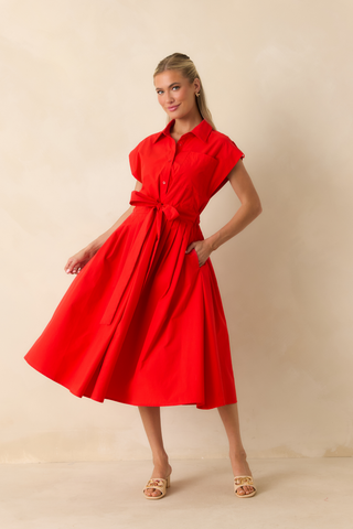 Model wearing the Prosperina Lana Midi Dress in Very Cherry featuring a vibrant red midi silhouette with a fitted bodice and full skirt.