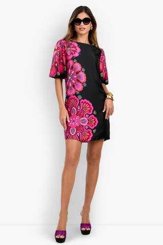Trina Turk Luv Dress in Multi featuring a black mini silhouette with oversized pink floral print, boat neckline, and short bubble sleeves.