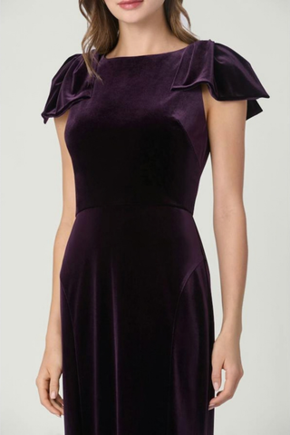 Shoshanna Brandis Dress in Dark Plum featuring stretch velvet, a boat neckline, draped bow shoulders, fitted bodice, and softly flared midi skirt.