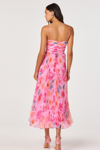 Woman wearing a pink multi floral pleated midi dress with spaghetti straps and fitted bodice from ASTR on a white background.