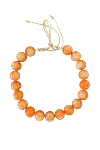 KMS Gems Chunky Beaded Necklace in Sunkist featuring oversized vibrant orange beads and an adjustable silk cord.
