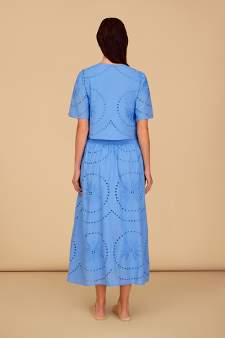 Blue eyelet cropped blouse with short sleeves and front slit detail paired with matching midi skirt
