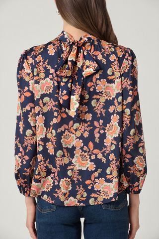 Shoshanna Tilly Top in Navy Multi featuring a floral-inspired satin print, gathered neckline, and long blouson sleeves.