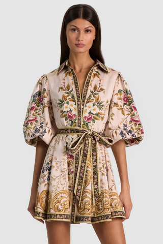 Alice + Olivia Lucy Mini Shirt Dress in True Grandeur featuring a colorful floral and paisley-inspired print, collared neckline, blouson sleeves, and adjustable tie waist.