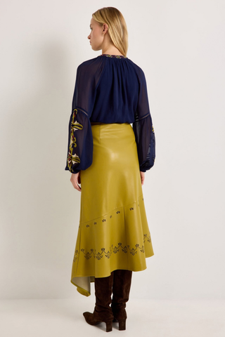 Marie Oliver Royce Blouse in Sundown featuring deep navy fabric, colorful embroidery, a tie neckline, and billowy sleeves.