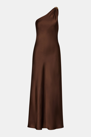 Steve Madden Aurorah Dress in Shaved Chocolate brown featuring a one-shoulder maxi silhouette, gold-tone hardware, and draped back scarf detail.