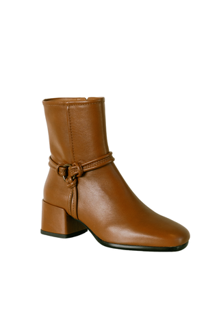 Homers Niki Bootie in Crimea Sella, a cognac brown ankle boot with buckle hardware, rounded toe, and block heel.
