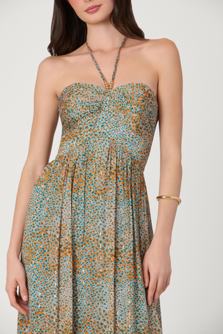 Woman wearing a strapless dress with a blue and orange pattern on a white background
