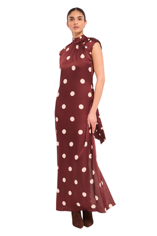 Misa Runi Dress in Polka Dots Mix featuring burgundy satin with oversized cream polka dots, a gathered high neckline, and a contrasting tie-back sash.