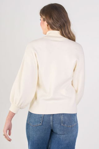 Emily McCarthy Lolli Sweater in Sandshell, a cream long sleeve sweater with a stand collar, V-neckline, and blouson sleeves.