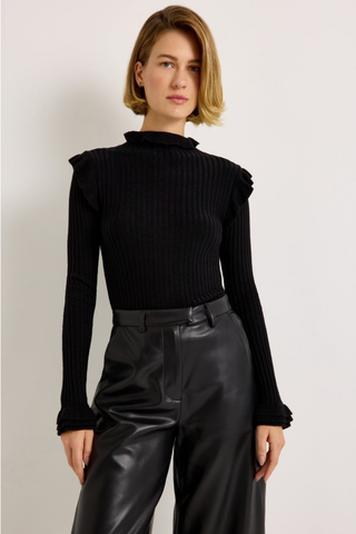 Marie Oliver Tinley Turtleneck in Black featuring fine ribbing, a fitted silhouette, fold-over ruffle neck, and ruffled cuffs.