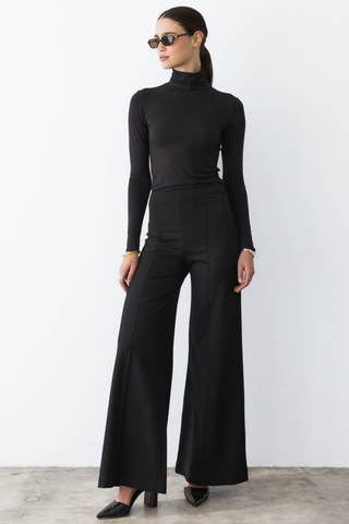 Ripley Rader Modal Turtleneck in Black featuring a fitted body-skimming silhouette, high neckline, and extra-long sleeves.