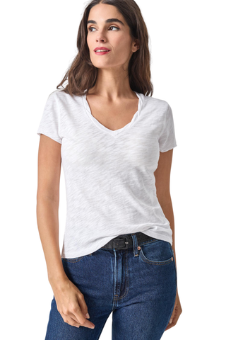 Model wearing the Lilla P Twisted Binding V-Neck Tee in White featuring lightweight textured slub cotton, a twisted V-neckline, and a flattering fitted silhouette.