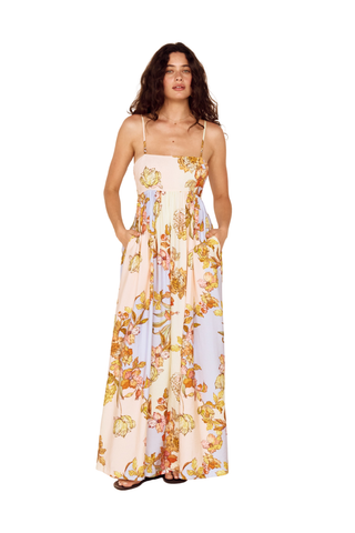 Model wearing the MINKPINK Fiore Tie Back Maxi Dress in Pastel Floral featuring a strapless neckline, flowing maxi silhouette, tie-back detail, and soft pastel floral print.